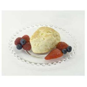 Scone with berries on a glass plate.