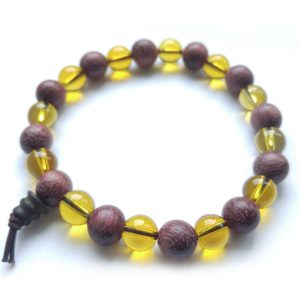 Wrist mala bracelet with alternating beads made of citrine and purpleheart wood.