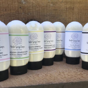 Seven squeeze bottles of lotion with different scents.