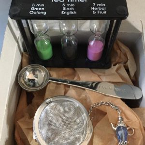 Tissue paper in a gift box with Ideal Brew Tea Timer, tea measuring spoon, tea ball infuser.