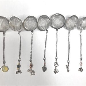 Seven stainless steel tea balls, all with different charms at end of chain.
